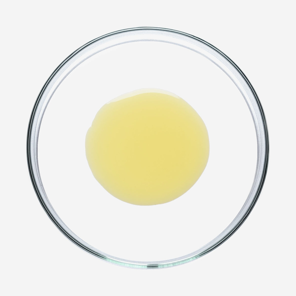 Gelbe Sun Shield Drops in einer Glasschale